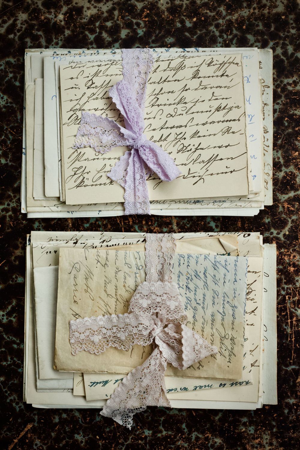 Bundles of old handwritten letters tied with lace ribbon